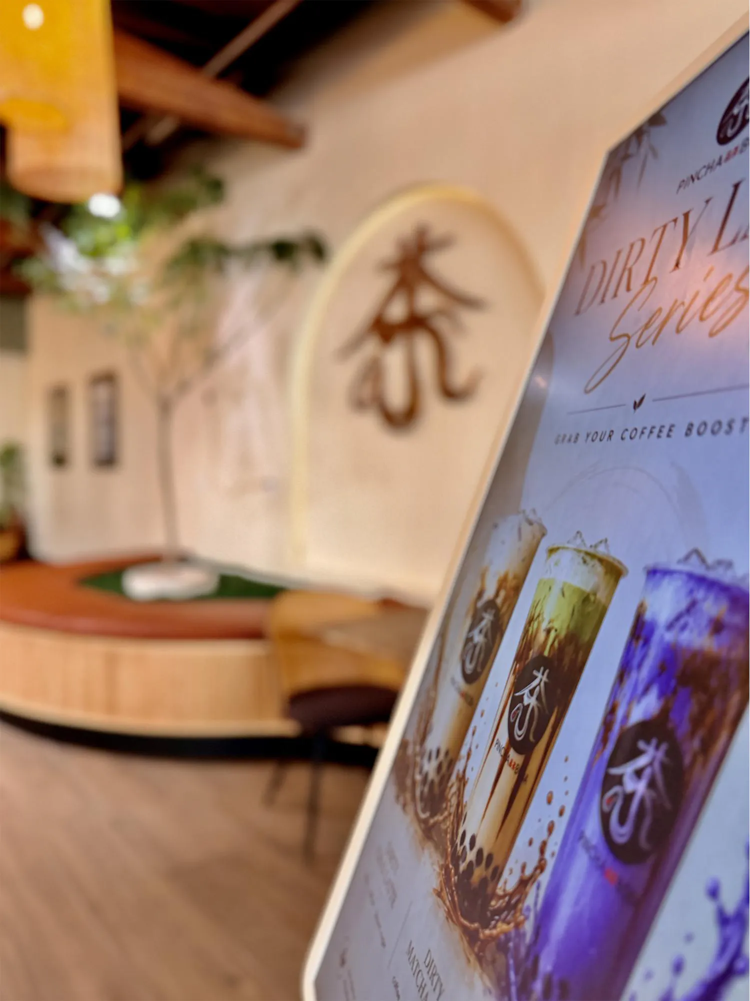 Bubble Tea Menu Display with Cozy Tea Shop Interior and Signature Drink Promotion