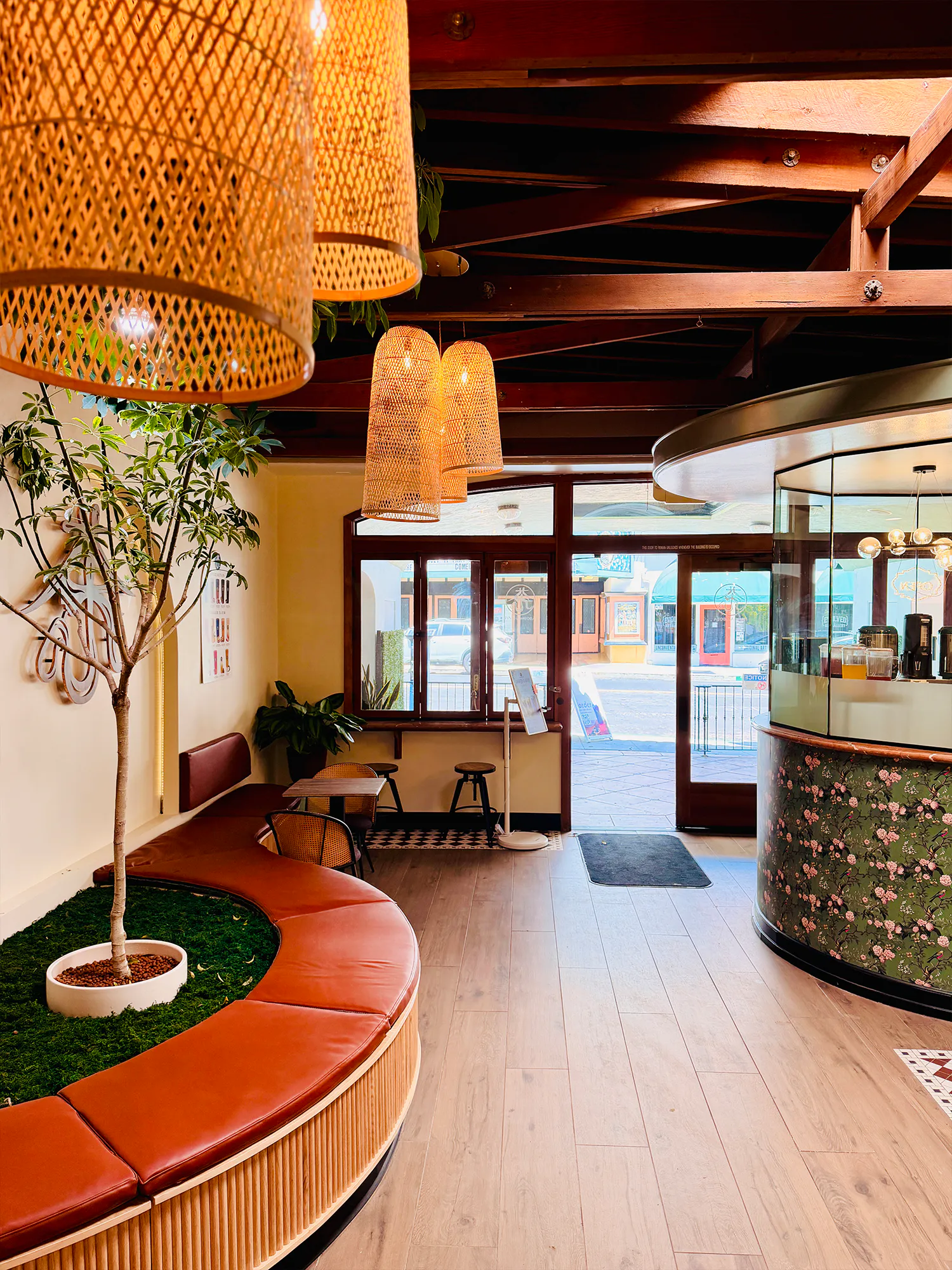 Elegant Tea House Interior with Woven Pendant Lights, Indoor Trees and Comfortable Lounge Seating