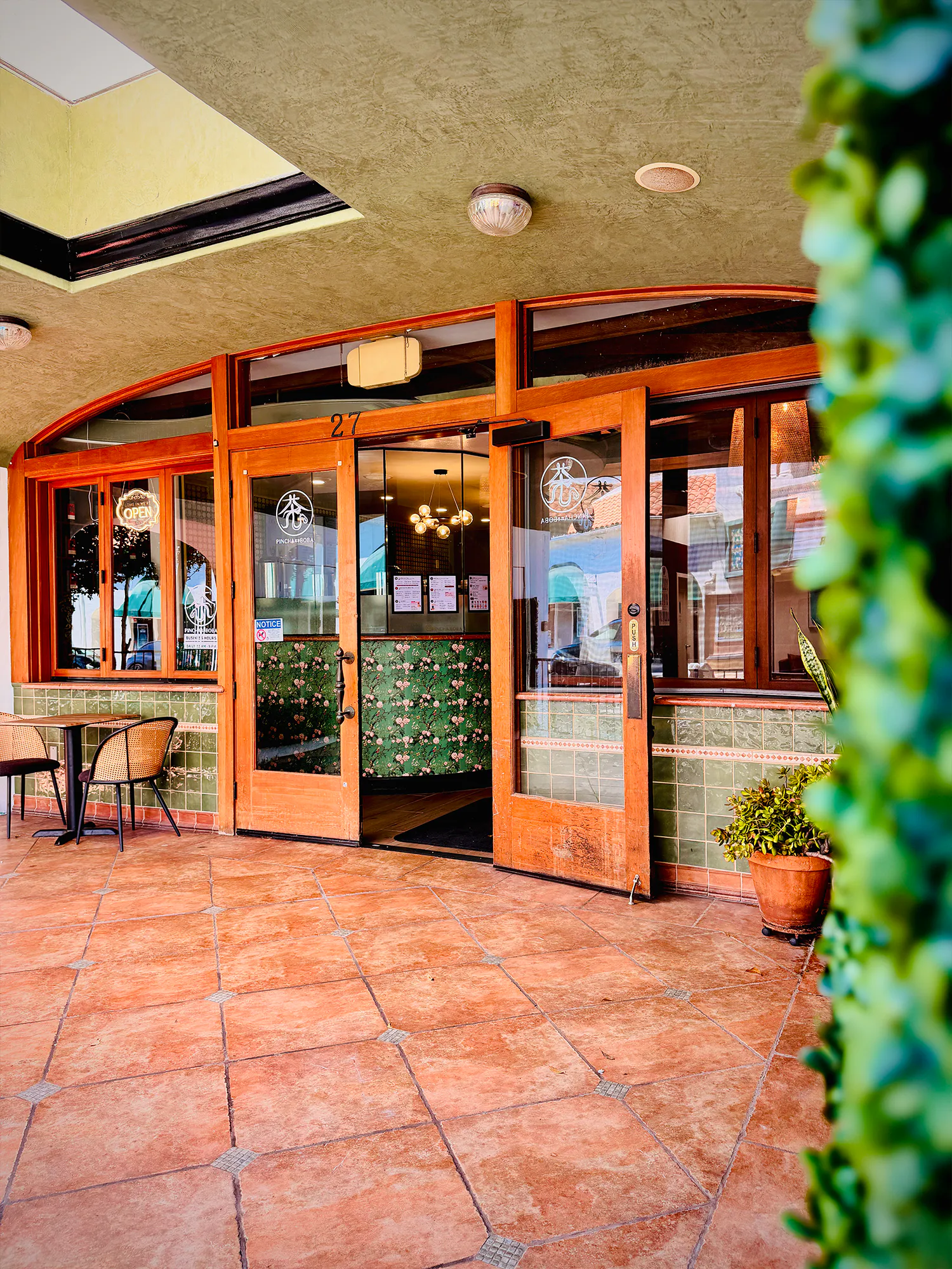 Pincha Boba Tea Shop Storefront with Open Entrance and Outdoor Seating Area
